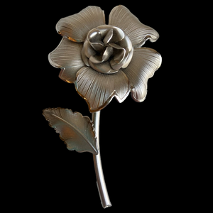 Vintage floral flower brooch pin with stem and leaf in textured satin silvertone
